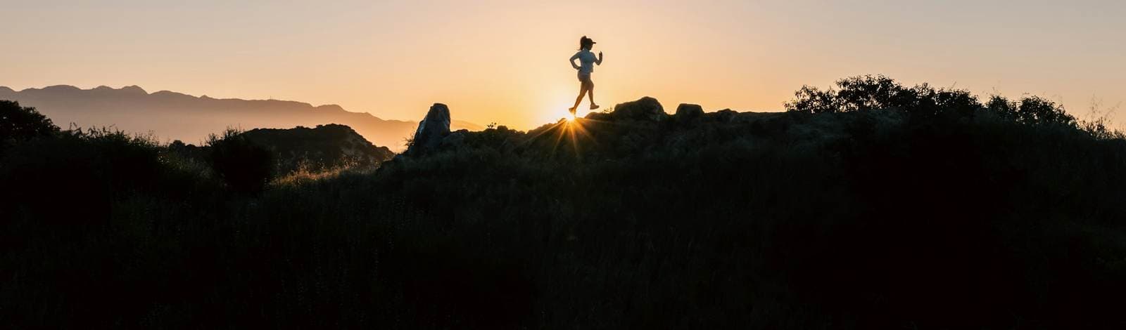 A runner on a ridge at first light