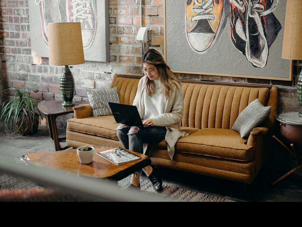 Someone sitting at home with a laptop open